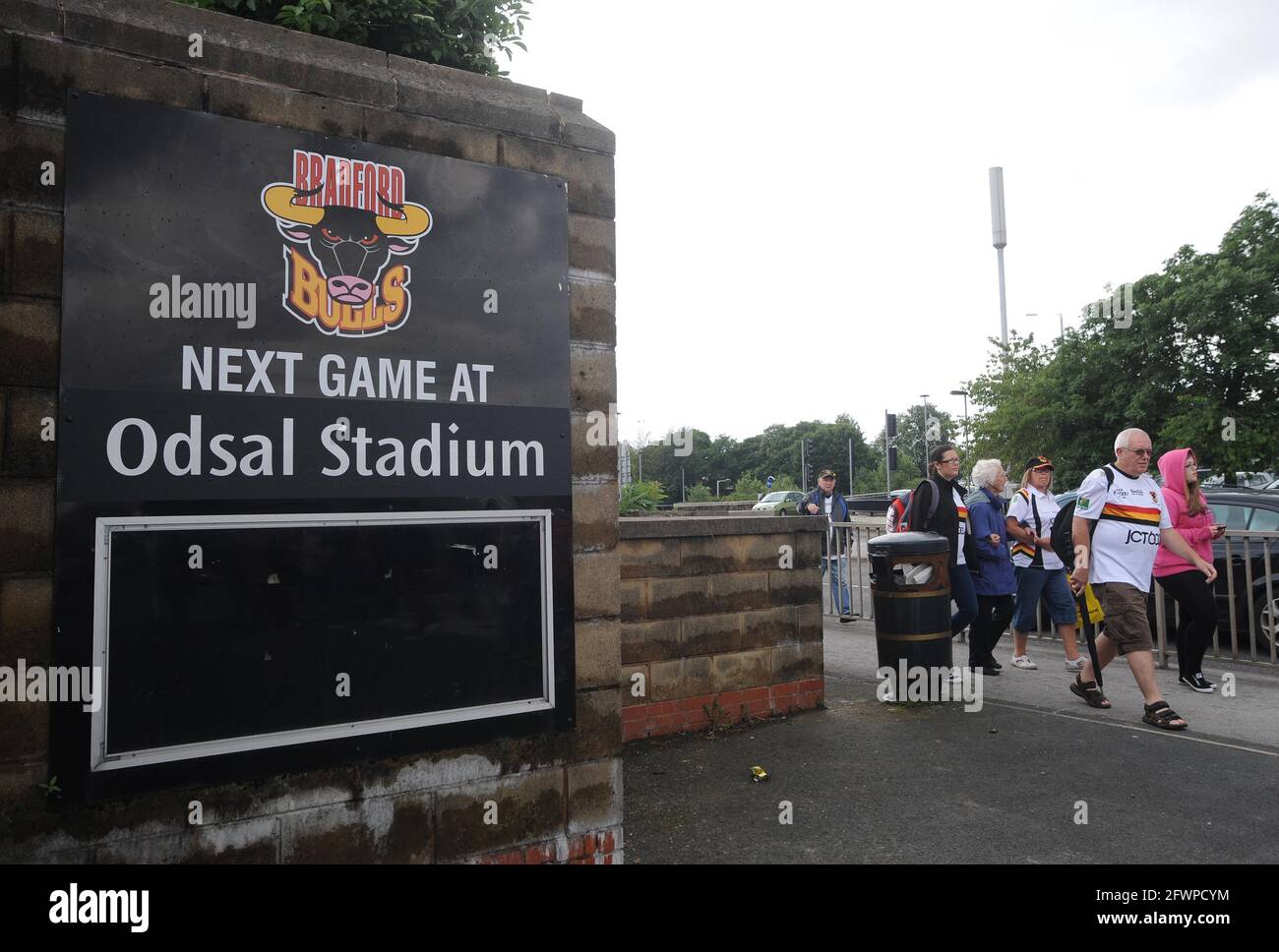 File photo dated 08-07-2012 of Bradford Bulls fans walk by a sign outside the Odsal Stadium, Bradford. Issue date: Monday May 24, 2021. Stock Photo