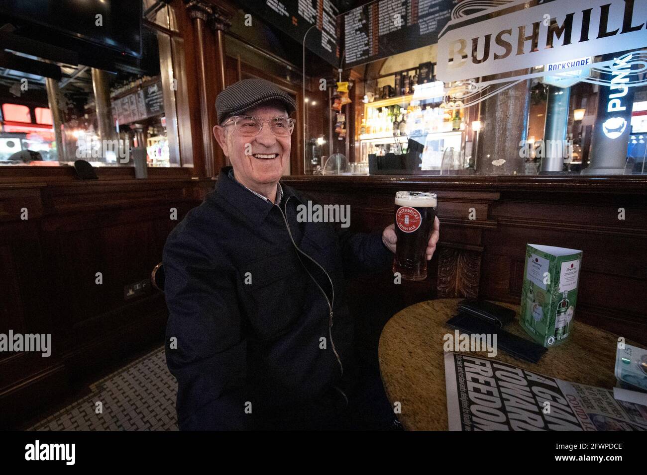 Tommy Brady, 78, enjoying his first pint of Smithwick's Ale since Christmas Eve at The Garrick Bar in Belfast, after the latest easing of the Covid-19 rules in Northern Ireland . Stock Photo