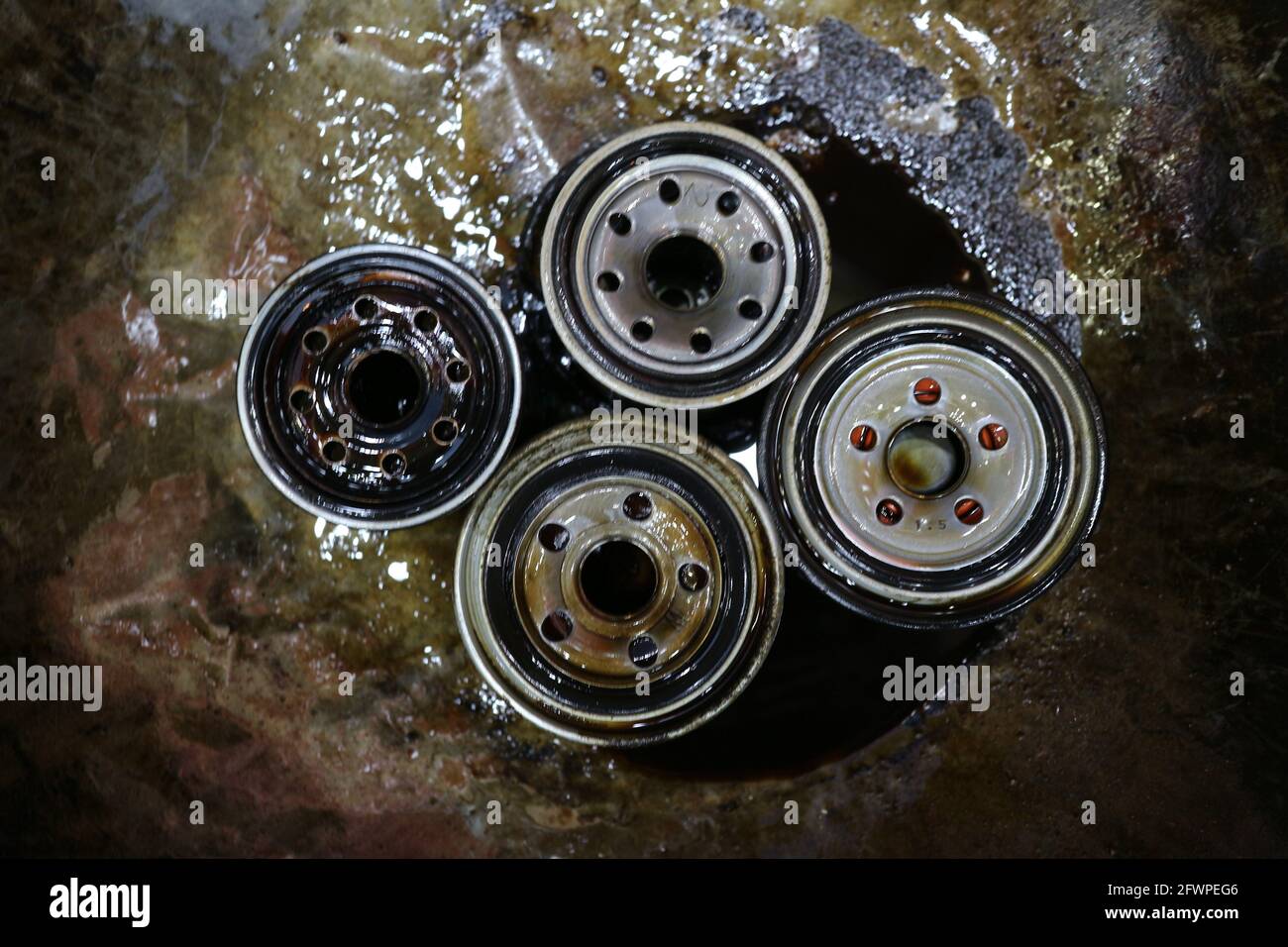 Kuwait City – Kuwait – April 15, 2021: Used car engine oil filters in metal tray Stock Photo