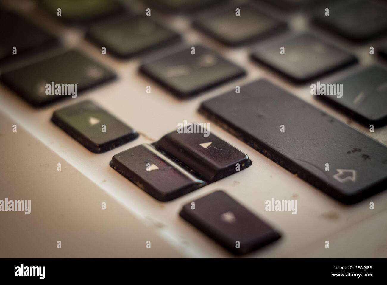 Picture of arrows of a dirty keyboard with black keys that would need
