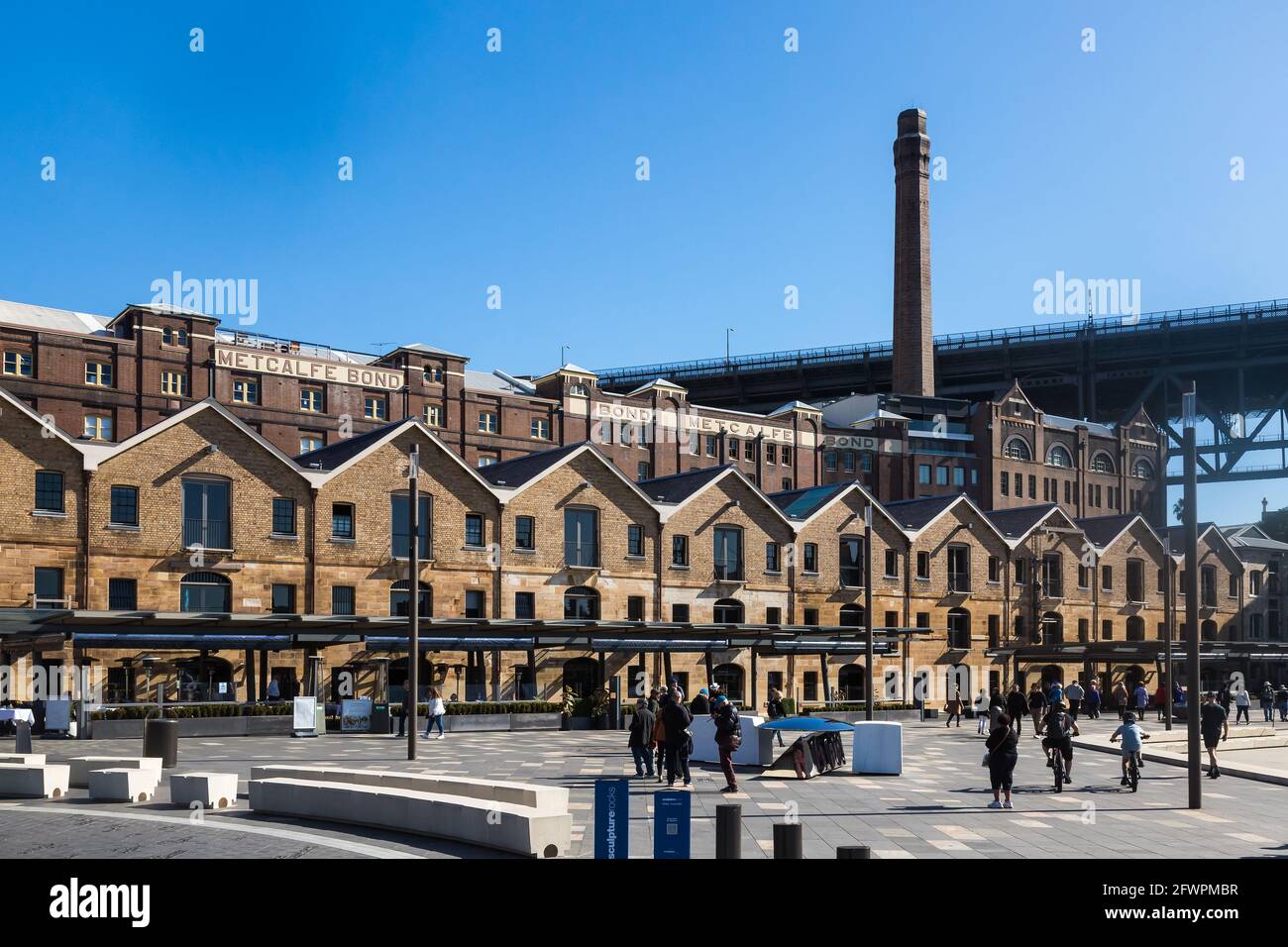 Views of Campbells Cove showing pre- federation heritage -listed buildings and warehouses in contrast to the modern city skyline. Stock Photo