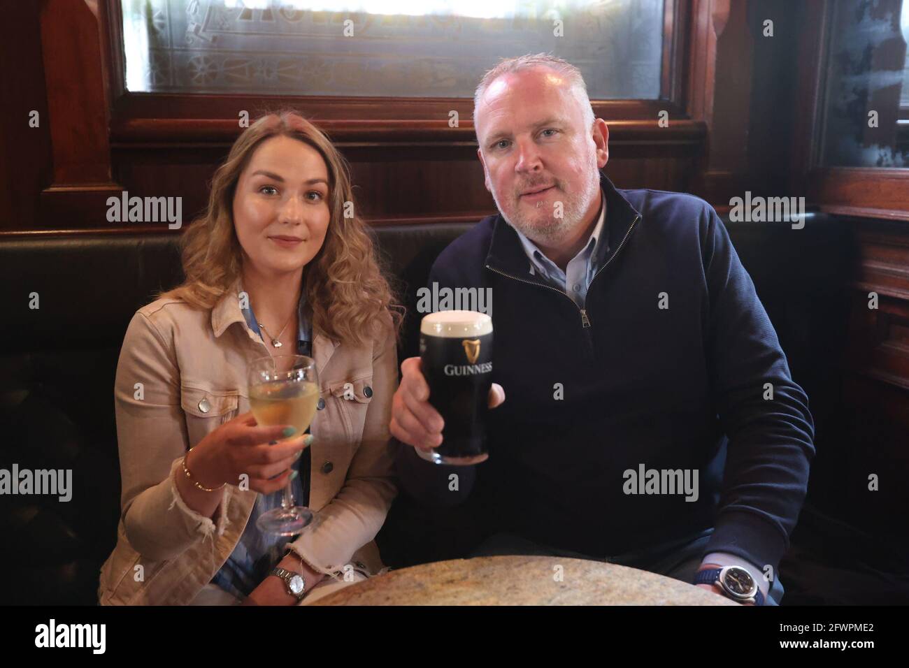 Natalie Knox and Campbell Brady enjoy a drink at The Garrick Bar in Belfast, after the latest easing of the Covid-19 rules in Northern Ireland . Stock Photo