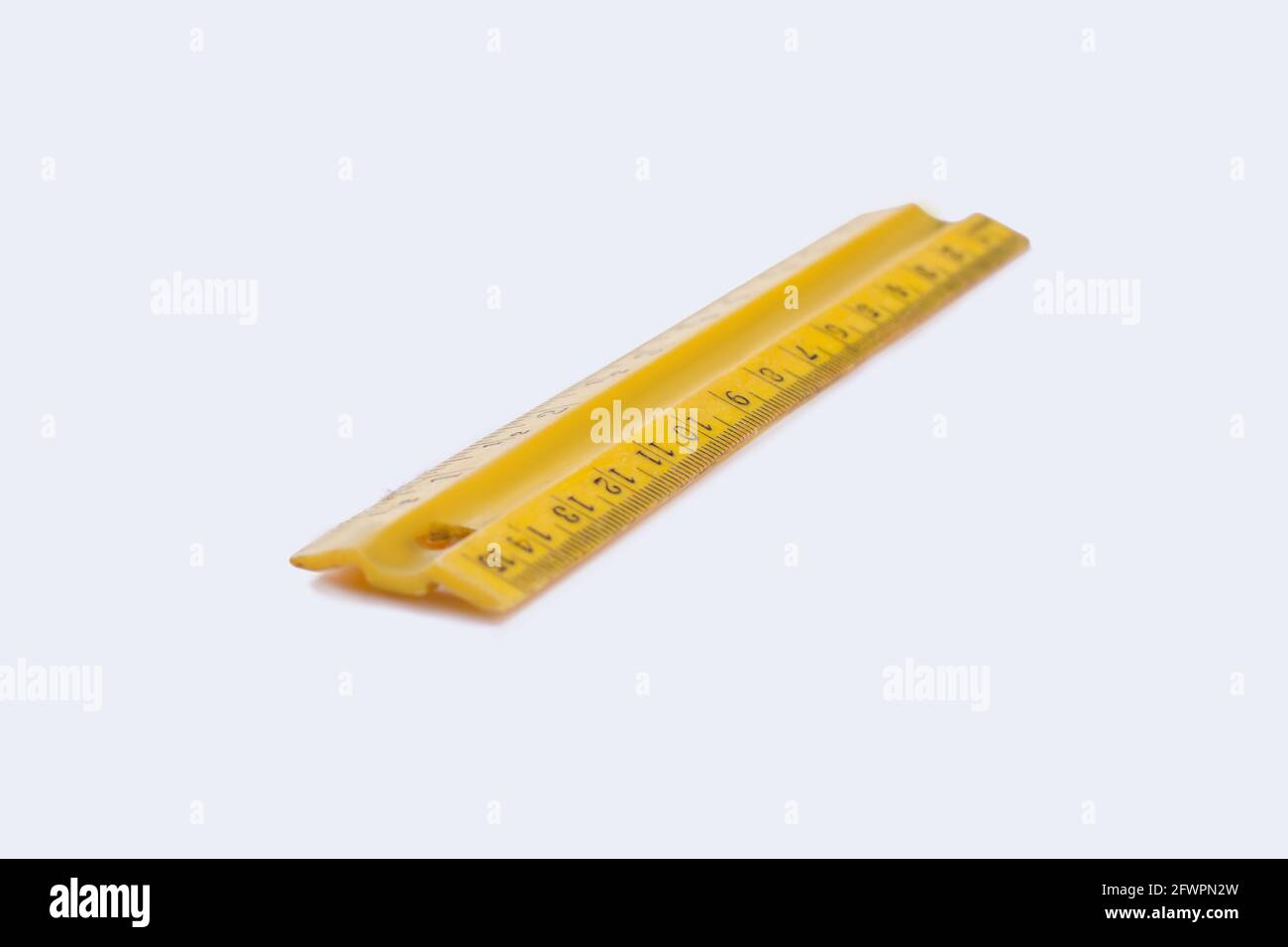 Yellow plastic ruler isolated on white background Stock Photo - Alamy