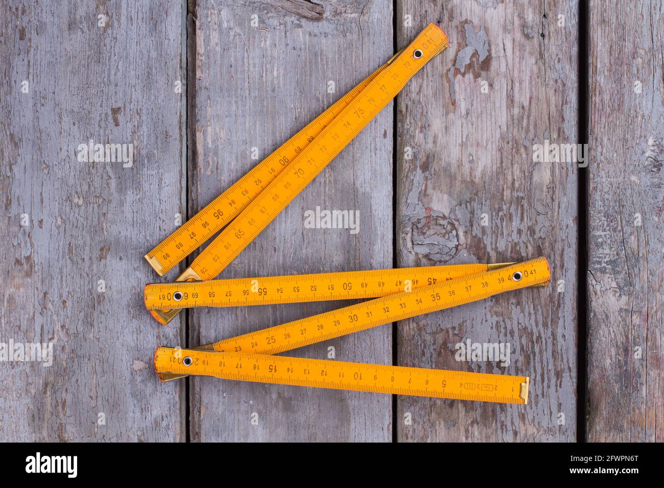 Folding ruler on vintage wooden background. Stock Photo