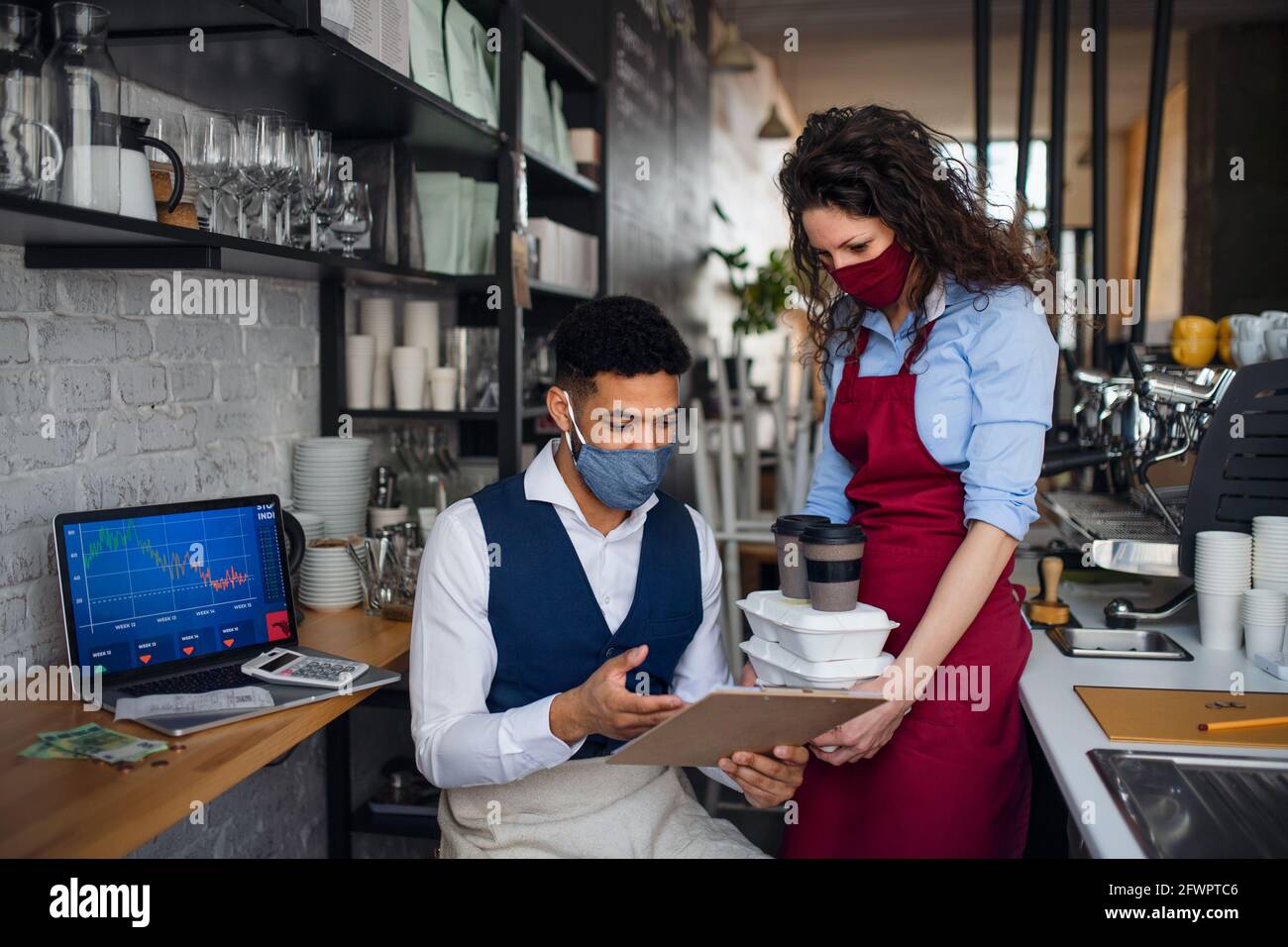 Coffee shop manager discussing issues with waitress in cafe, small ...