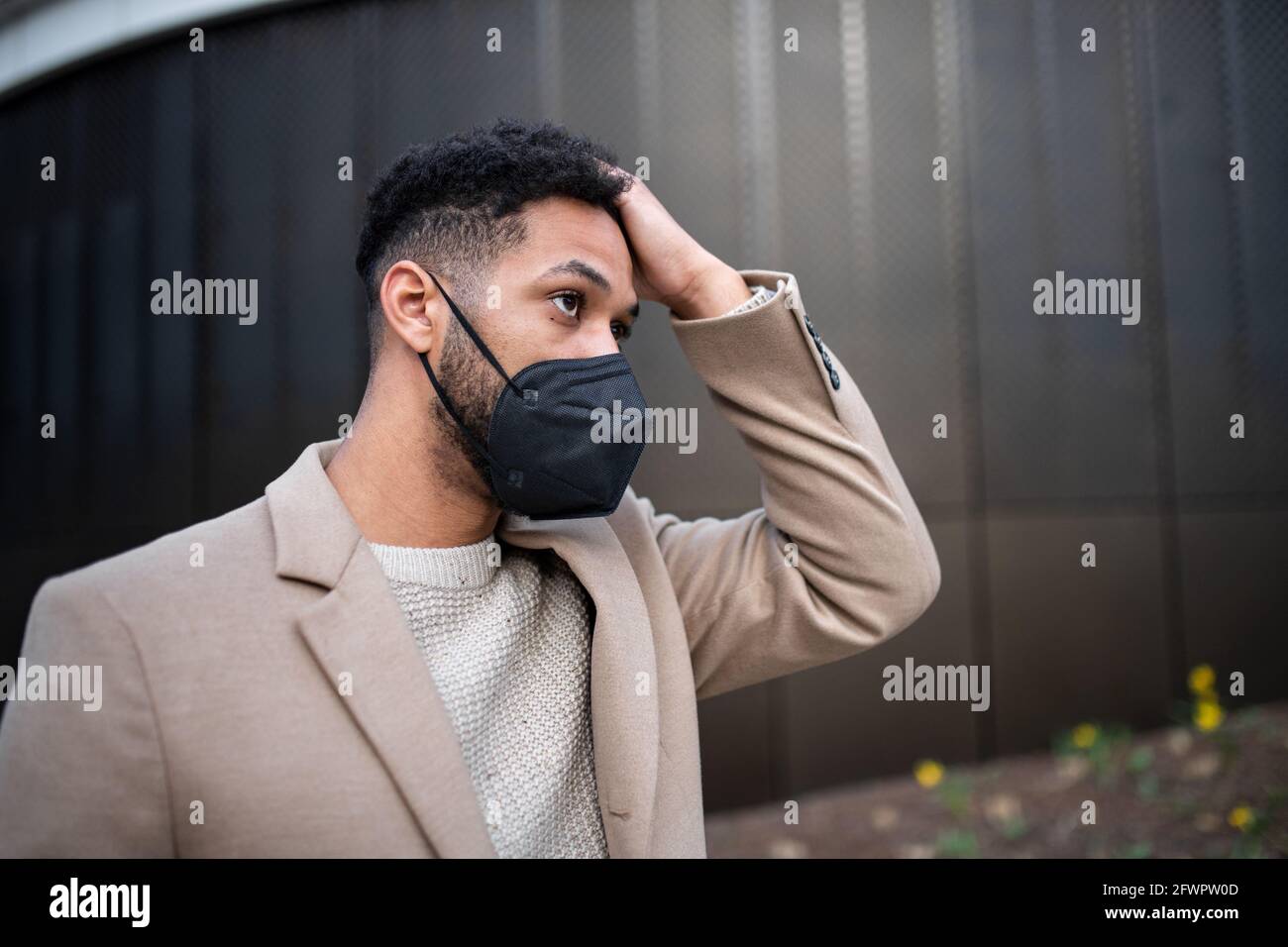 Portrait of man on the way to work outdoors in city, coronavirus concept. Stock Photo