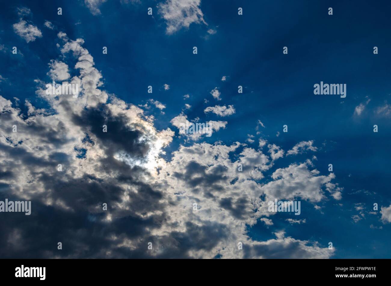 Summer sun hidden behind the clouds Stock Photo