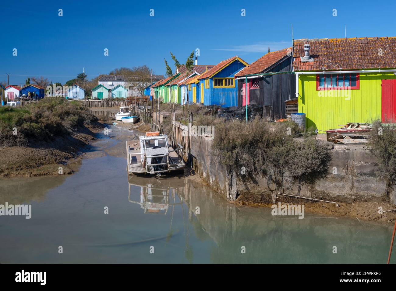 Chateau Oleron fishing harbour colourful cabins and oyster farming boats at Oleron Island, Charente Maritime, France on west Atlantic coast Stock Photo