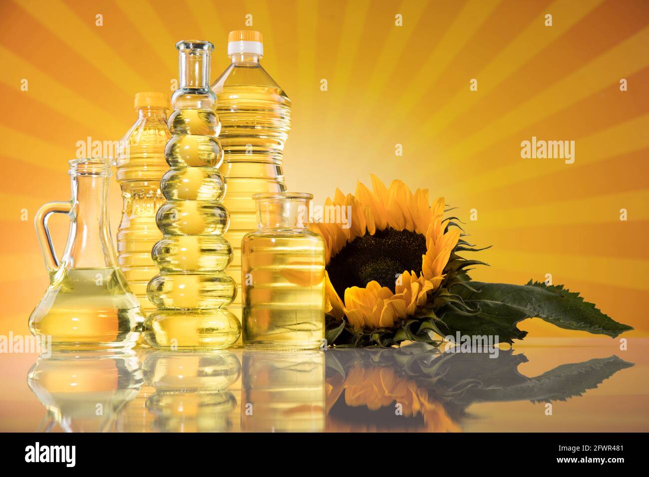 Sunflower oil, olive oil on sunburst orange background Stock Photo Alamy