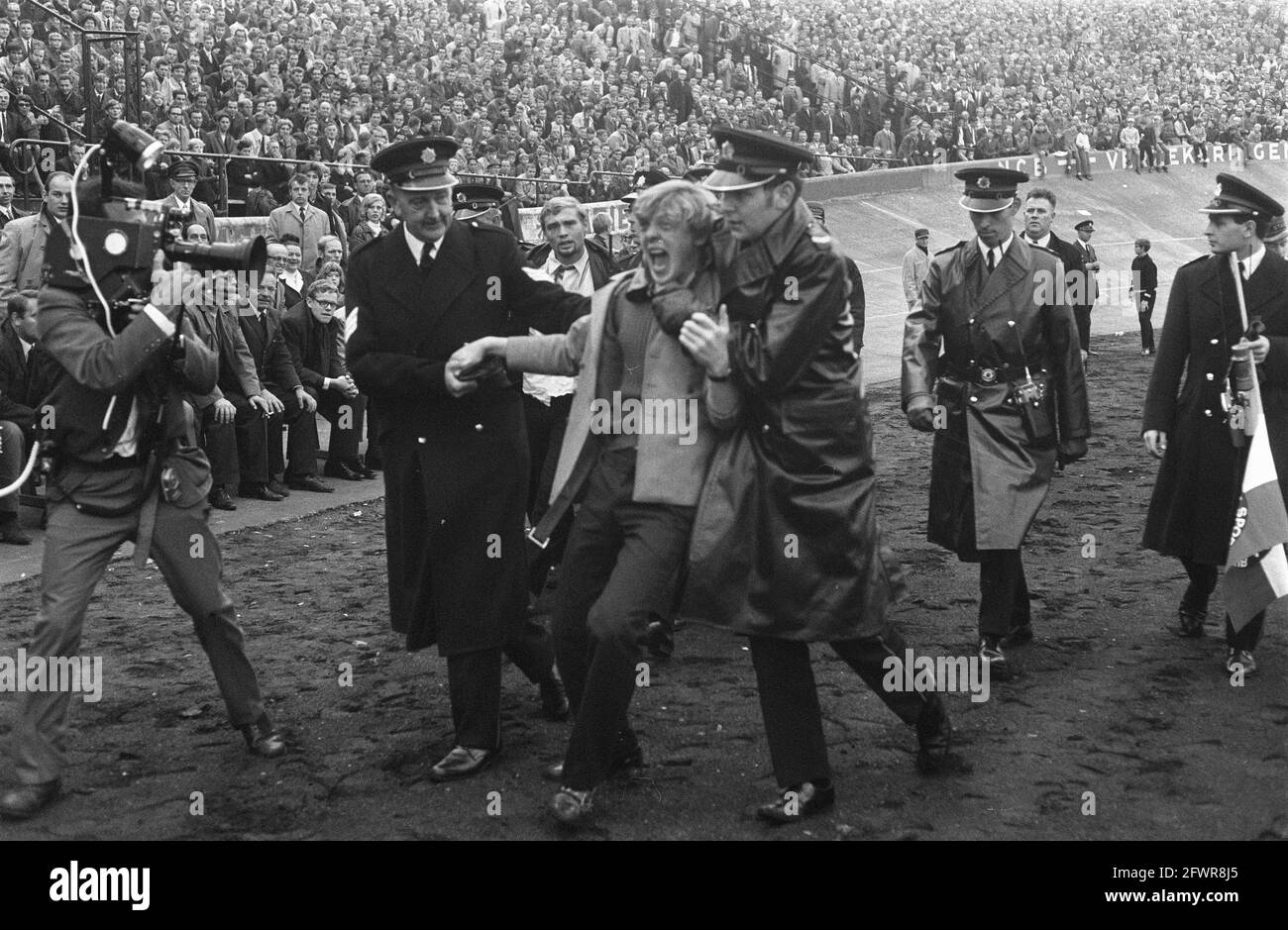 NEC v Feyenoord 0-2. Police officers remove supporter, October 26, 1969, POLICE AGENTS, sports, supporters, soccer, The Netherlands, 20th century press agency photo, news to remember, documentary, historic photography 1945-1990, visual stories, human history of the Twentieth Century, capturing moments in time Stock Photo