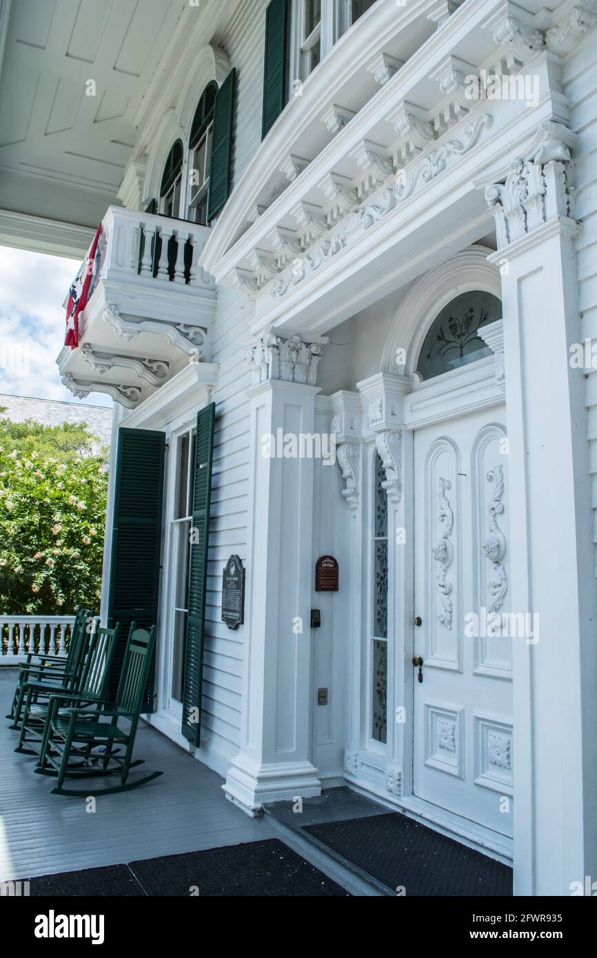 Entrance to the Bellamy Mansion in historic Downtown Wilmington, North Carolina. Rocking chairs on the expansive front porch of this antebellum estate. Stock Photo