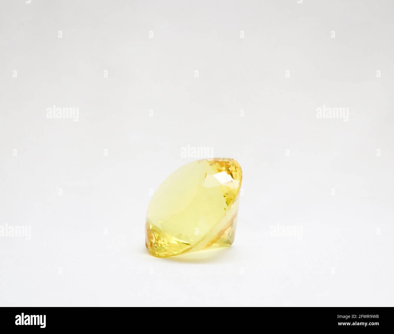beautiful, majestic  and perfectly cut yellow glass diamond isolated in a white background Stock Photo