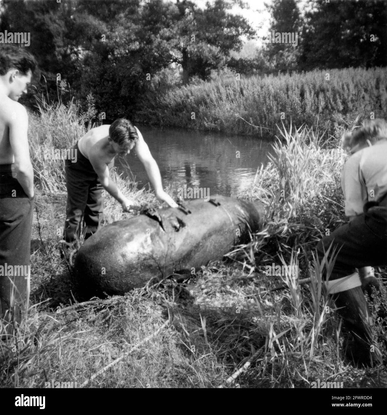 Members of the Royal Air Force bomb disposal unit dealing with Second World War ordnance, having extracted it from a river. 1950s/60s Stock Photo