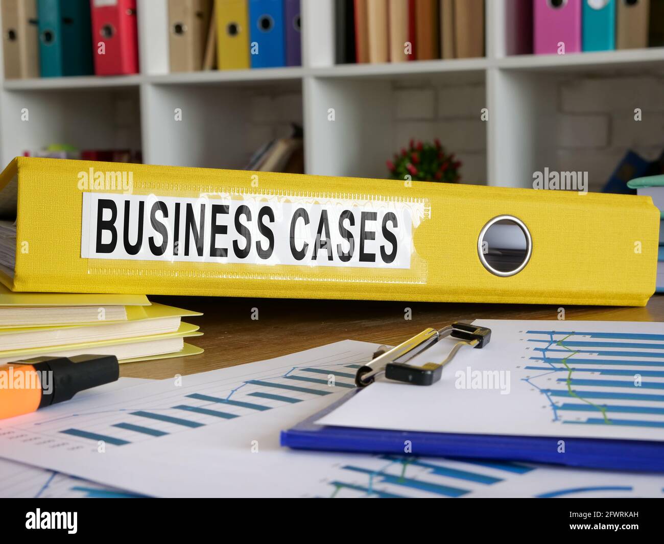 Business cases in the yellow folder on the desk. Stock Photo