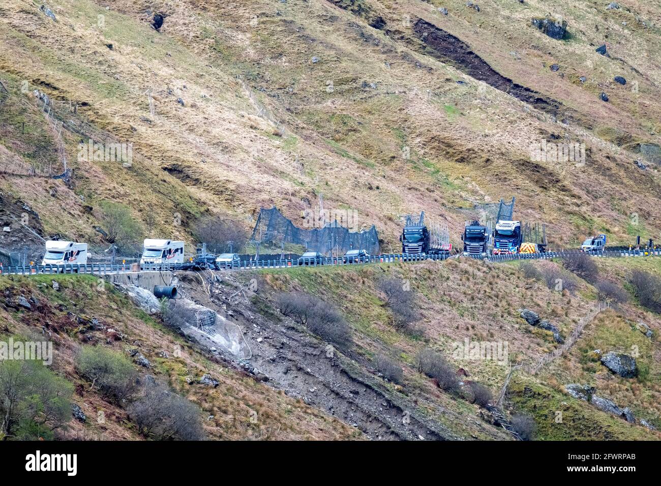 Traffic passing through traffic control on the A83 at the Rest and be Thankful, Argyll, Scotland. The road is under repair due to landslides. Stock Photo