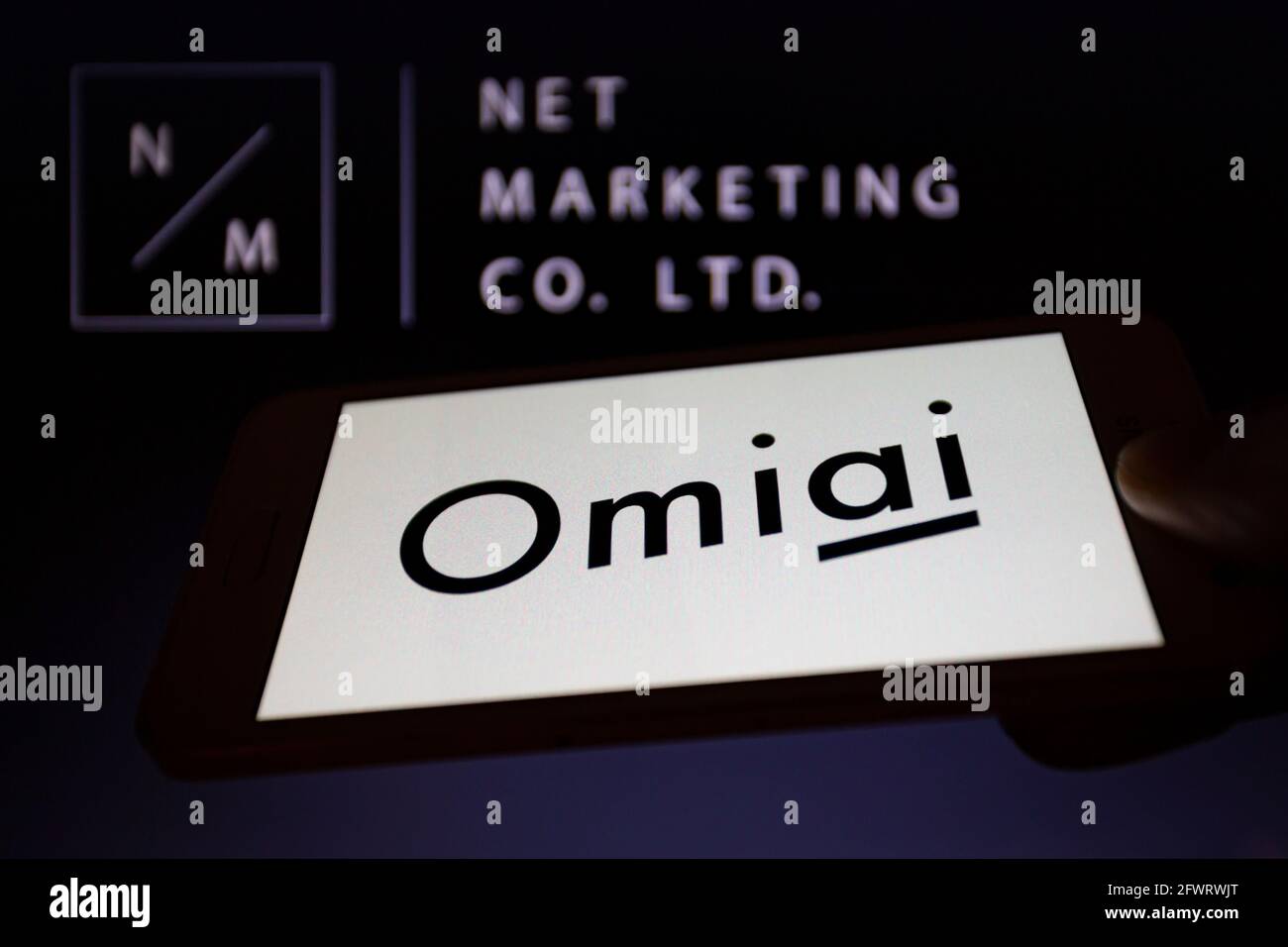 Asuncion Paraguay 24th May 2021 Illustration Photo Logo Of Omiai One Of Japan S Most Popular Dating Apps Is Displayed On A Smartphone Backdropped By Its Operator Net Marketing Co Ltd Logo