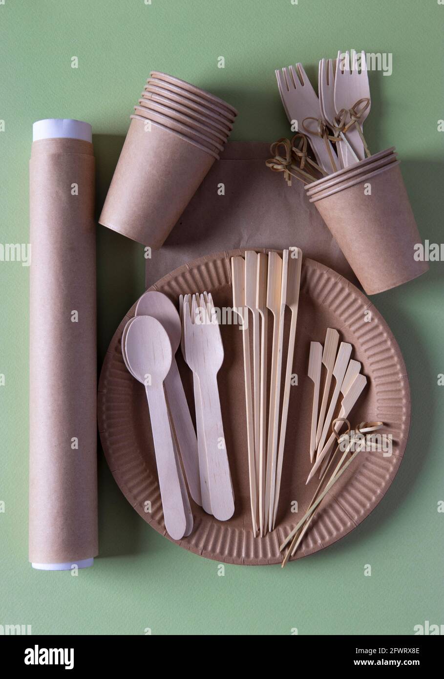 Disposable biodegradable tableware on craft paper plate forks, spoons