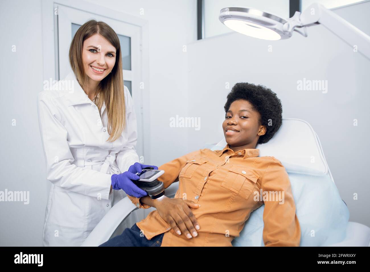 Oncology, skin cancer detection. Pleasant young woman, doctor