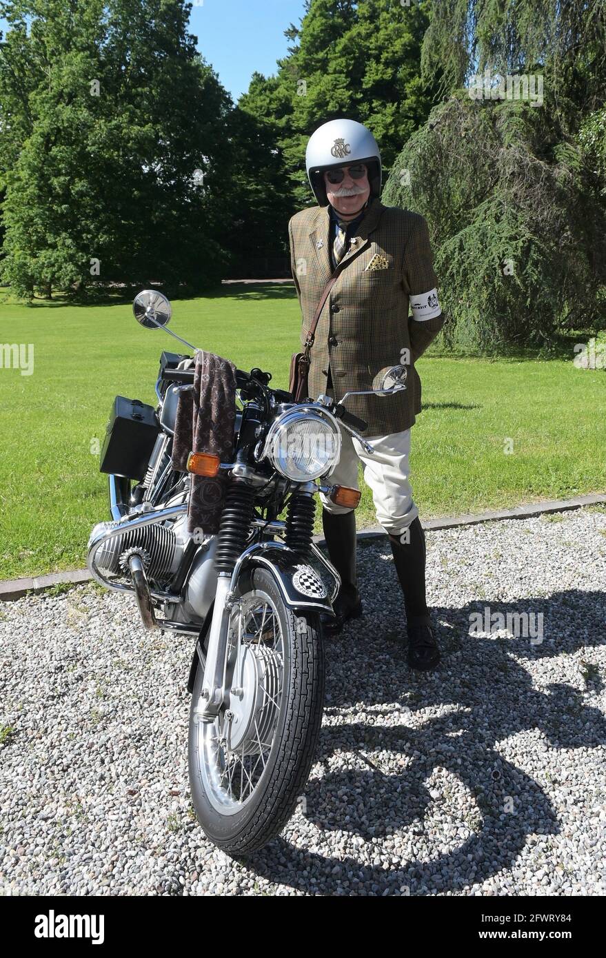 Varese, Italy. 24th May, 2021. Varese, Italy Distinguished Gentleman's Ride world event gathering of motorcyclists of both sexes dressed in vintage and current style in Varese at Villa Ponti In the photo: motorcyclist with his motorcycle Credit: Independent Photo Agency/Alamy Live News Stock Photo