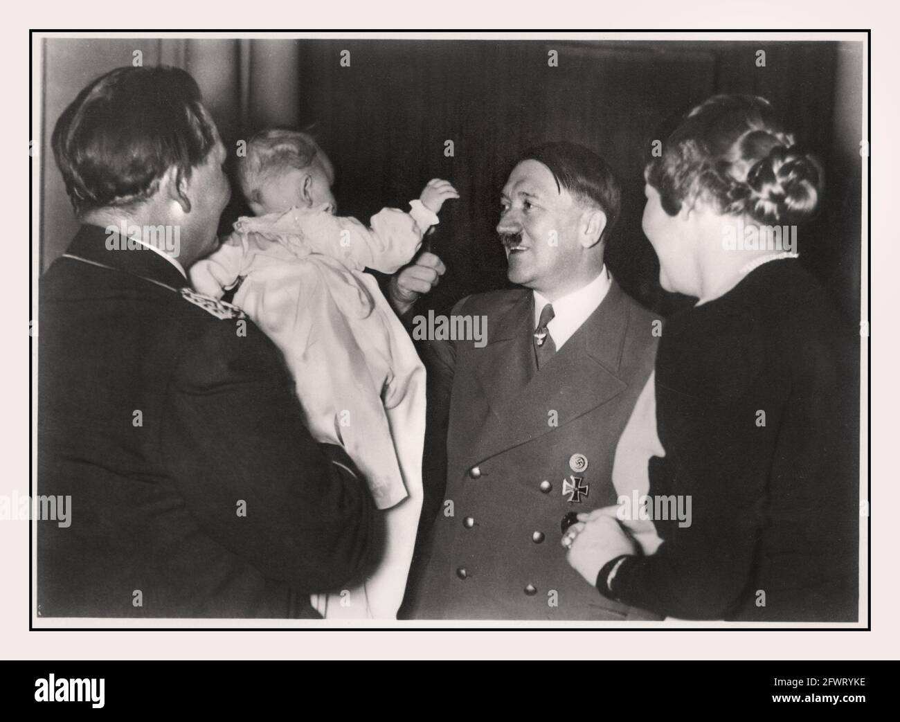 Adolf Hitler and baby 1939, 'The leader in the circle of the Göring family' Adolf Hitler greets Edda Carin Wilhelmine Göring the only child of German politician, military leader, and leading member of the Nazi Party Hermann Göring, by his second marriage to the German actress Emmy Sonnemann Stock Photo