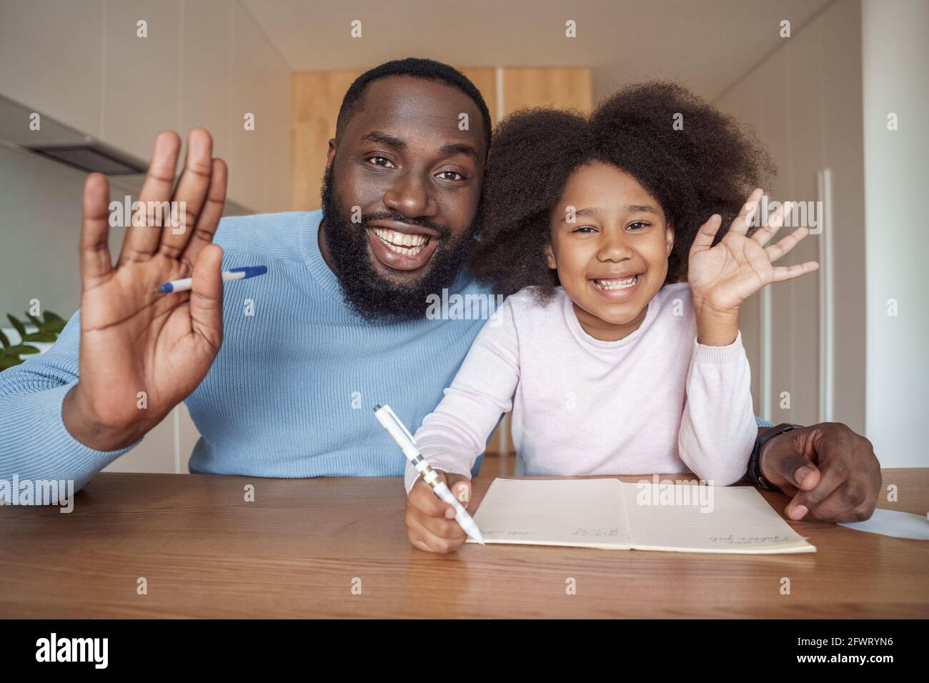 Father and daughter african amercian family smiling waving hand to camera Stock Photo
