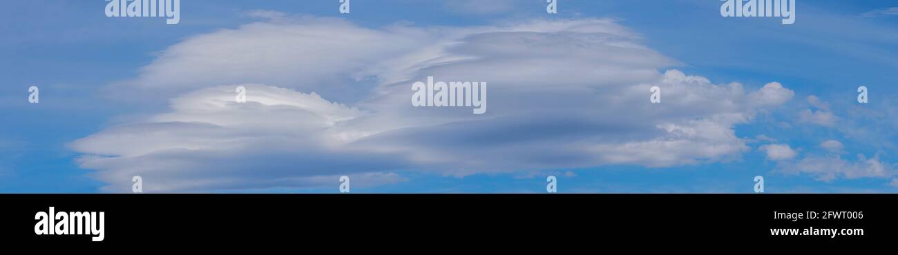 Blue sky with lenticular cloud formations, a rare natural phenomenon ...