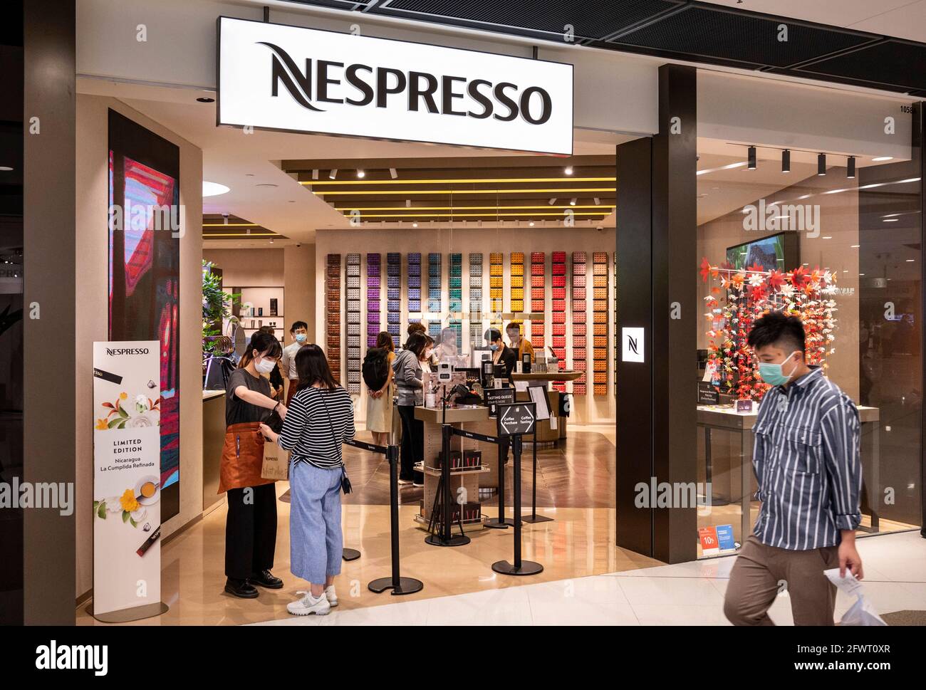 Hong Kong, China. 24th May, 2021. A shopper enters the Swiss high-end and  world leader in coffee capsules brand store Nespresso in Hong Kong. (Photo  by Budrul Chukrut/SOPA Images/Sipa USA) Credit: Sipa