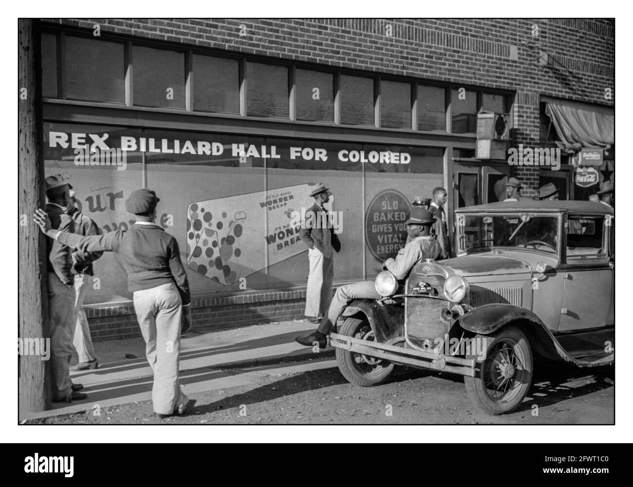 Racial Segregation USA BEALE STREET 1939 ‘Rex Billiard Hall For Colored Only’ Bar Juke Joint segregation by race racist Civil Rights apartheid separation by colour. Group of African American young men standing outside in front of a billiard hall waiting for it to open. Beale Street in Memphis, Tennessee. Photograph by Marion Post Wolcott, c1939. Stock Photo