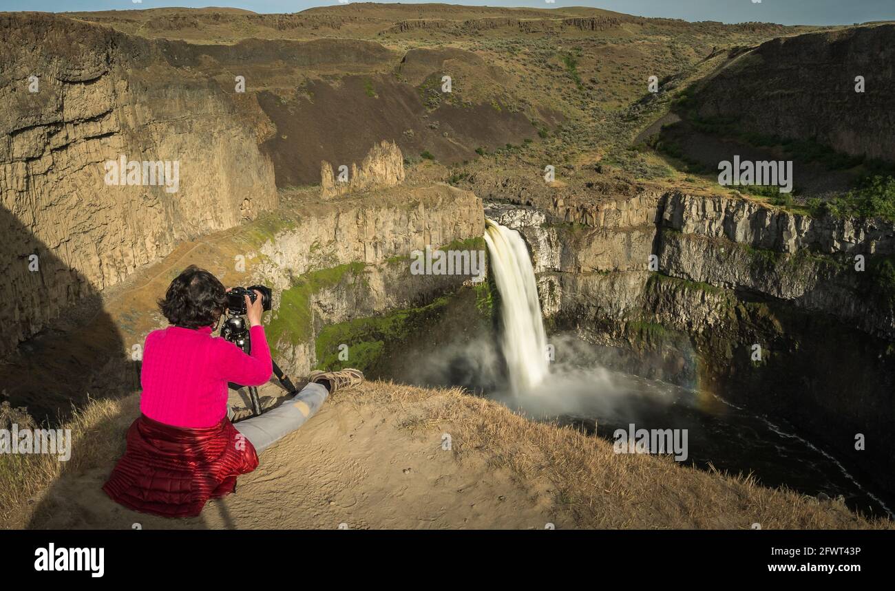 Girl taking photo of Palouse Falls in Washington State Park Stock Photo