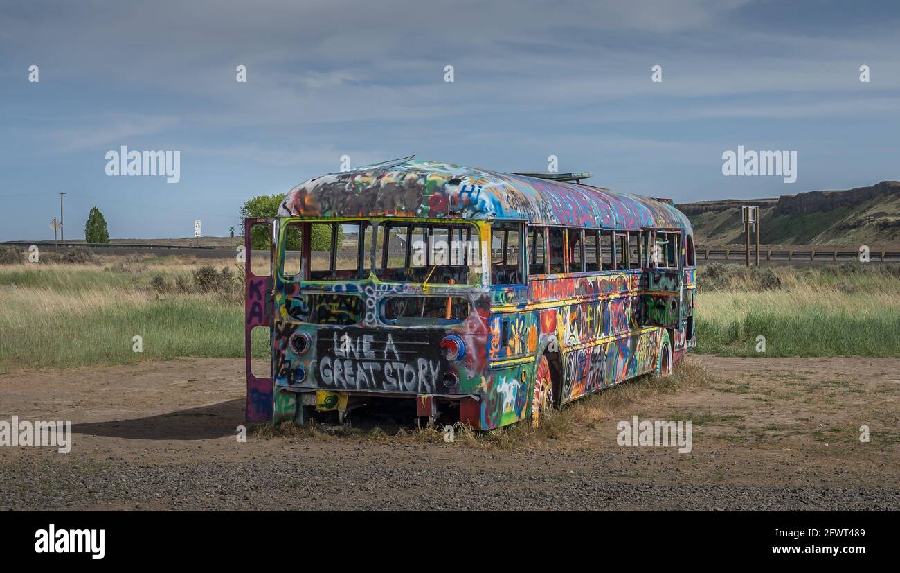 That PNW bus is an old abandoned school bus is still standing after many years.  Now is in a field alongside highwa Stock Photo