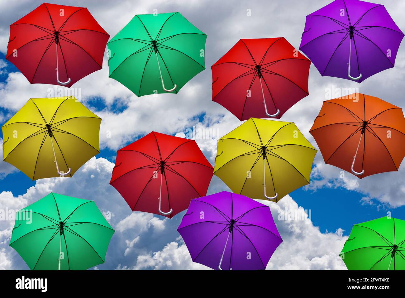 colorful umbrellas fly in the sky to the clouds Stock Photo - Alamy