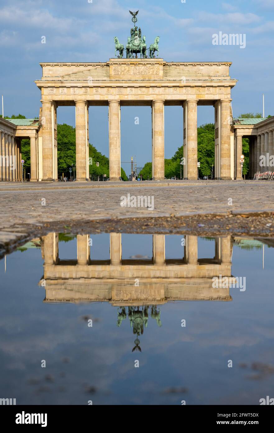 The famous Brandenburger Tor in Berlin with no people reflected in a puddle Stock Photo