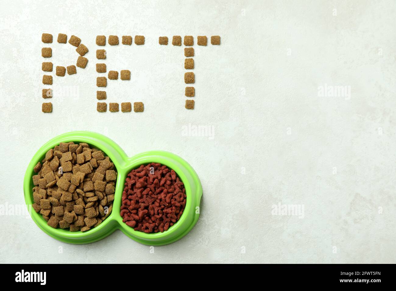 Word Pet made of feed and bowls of feed on white textured background