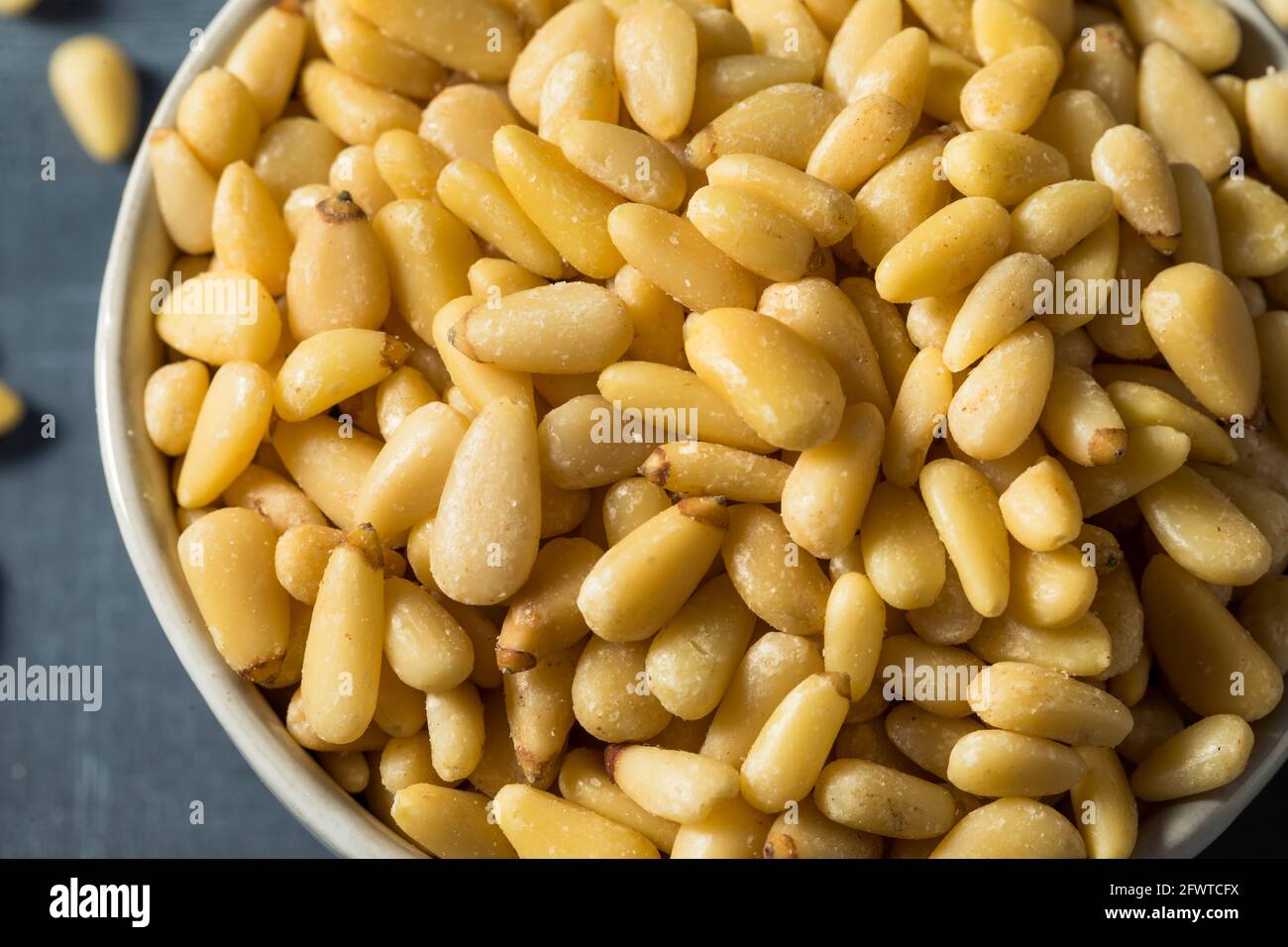 Raw Organic Pine Nuts in a Bowl Stock Photo