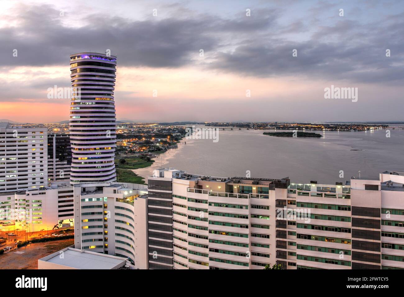 Guayaquil skyline at sunset as seen from Cerro de Santa Ana (St. Ana Hill) with new appartment buildings and The Point. Ecuador. Stock Photo