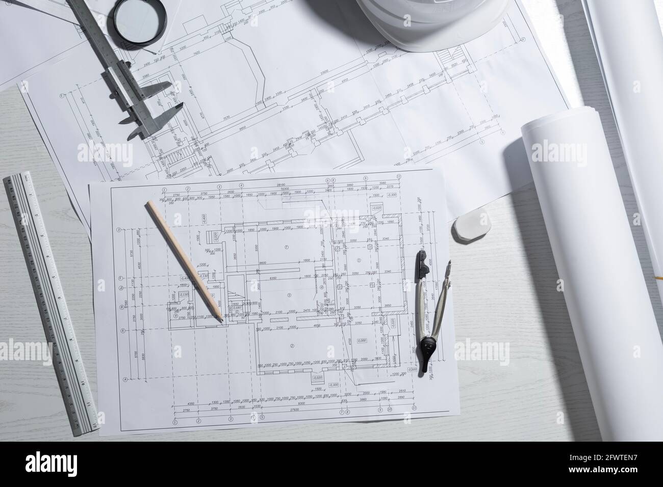 Work desk of the architect of the design project sketches. Workplace of a civil engineer creating blueprints. Top view. Stock Photo