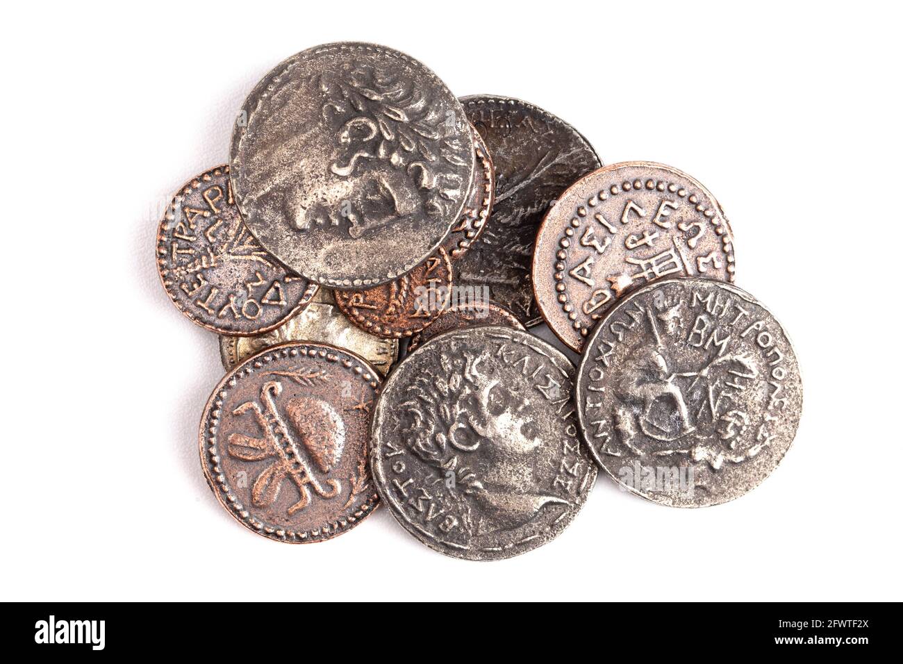 A Pile of Ancient Roman Coin Replicas Isolated on a White Background