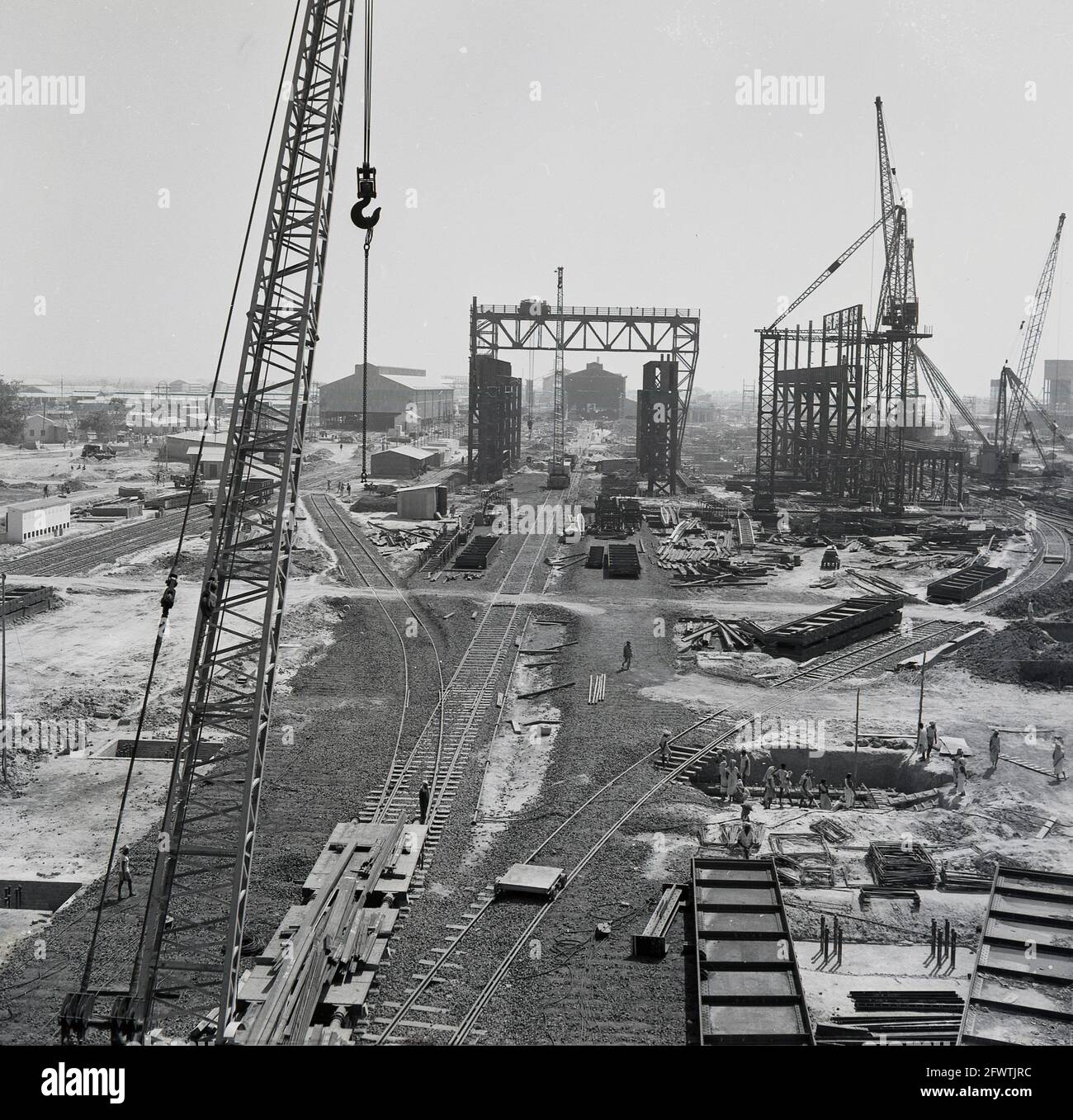 Late 1950s, historical, aerial view of the construction of the giant Durgapur Steel Plant, Durgapur, West Bengal, India, After independence, the steel plant was one of the first major construction projects in India and in 1957 an indian company, Patel Engineering, in collaboration with a British business, Cementation UK, undertook the entire civil engineering and earth works. The massive industrial complex, involved building and machinery foundations, concrete piles, building structure, railway tracks, roads and servces such as drainage and a water supply. Stock Photo