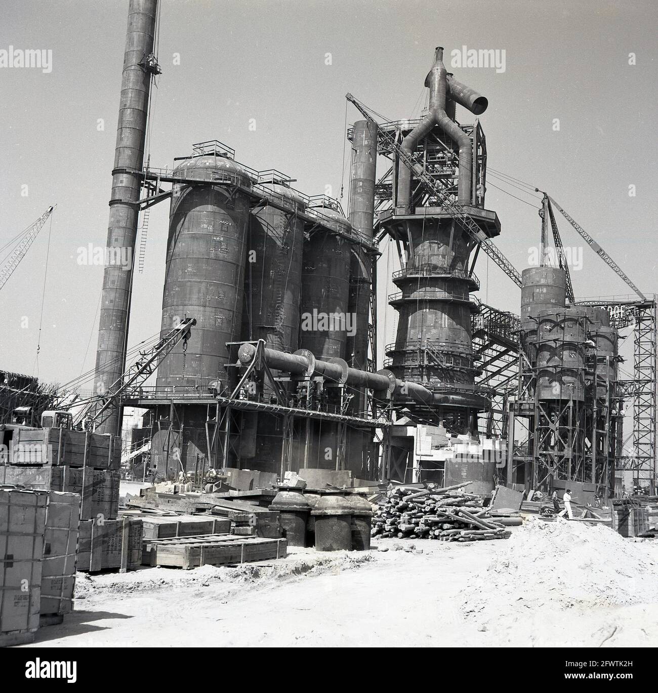 Late 1950s, historical picture of construction of the Durgapur Steel Plant, Durgapur, West Bengal, India, After independence, the steel plant was one of the first major construciton projects in India and in 1957 an indian company, Patel Engineering, in collaboration with a British business, Cementation UK, undertook the entire civil engineering and ground works. The giant project involved building and machinery foundations, concrete piles, building structure, railway tracks, roads, drainage, water supply. Stock Photo