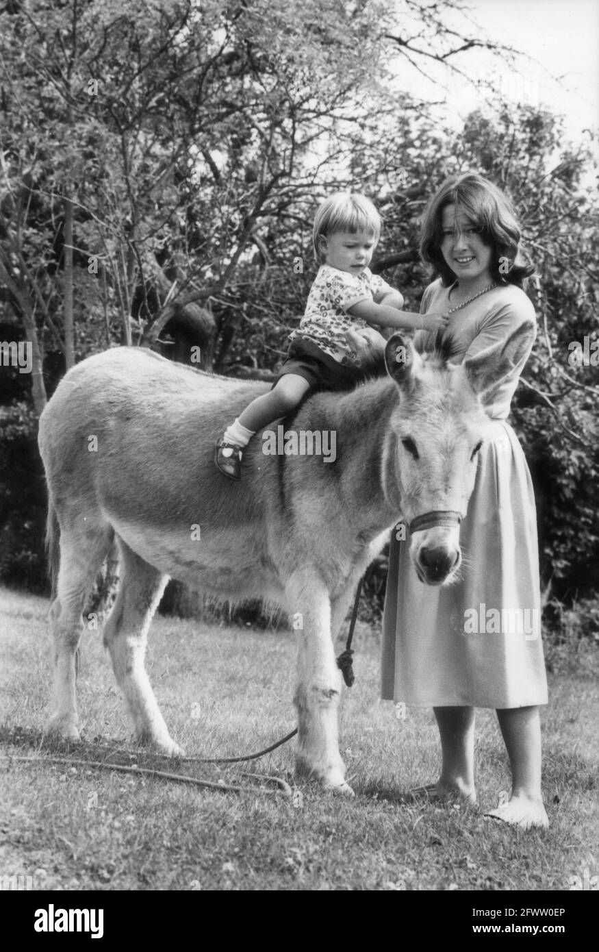 Mother and child with pet donkey Britain 1979 Stock Photo
