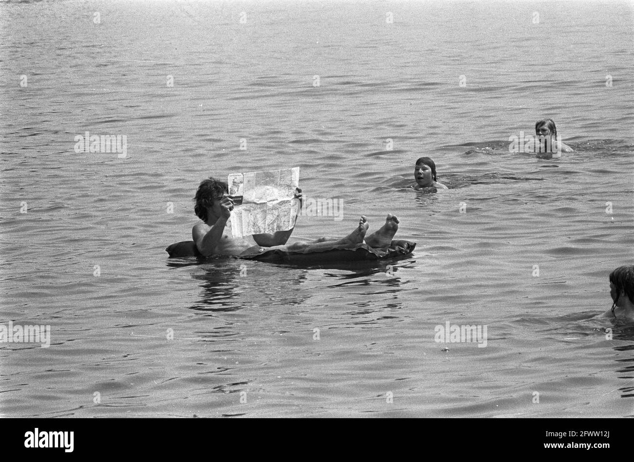 On airbed in Sloterplas with map, June 26, 1973, airbeds, puddles, The Netherlands, 20th century press agency photo, news to remember, documentary, historic photography 1945-1990, visual stories, human history of the Twentieth Century, capturing moments in time Stock Photo