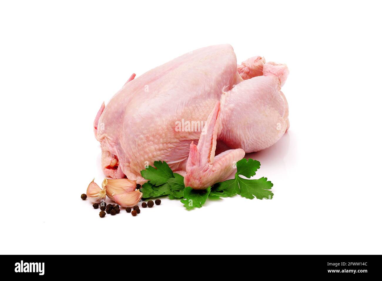 whole raw chicken carcass isolated on white background with parsley