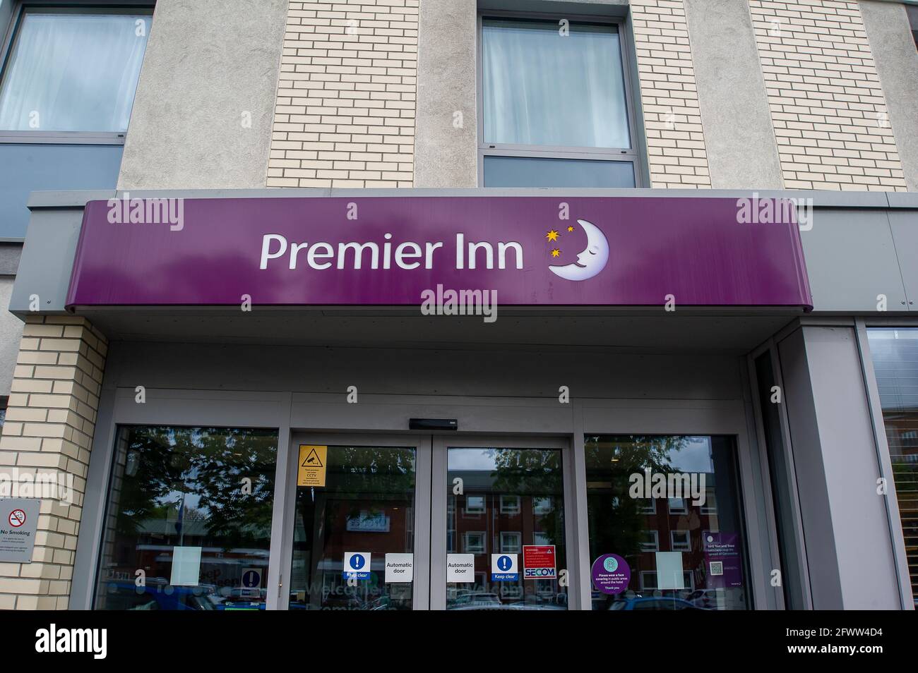 Slough, Berkshire, UK. 23rd May, 2021. The Premier Inn has reopened to customers following the easing of the Covid-19 restrictions. Shoppers out in Slough High Street today. The Covid-19 seven day rolling infection rates per 100,000 people in Slough for the week ending May 18 has risen to 25.4, up from 22.7. Given that the number of positive Covid-19 Indian variant cases are starting to rise, the possibly of the entire lifting of lockdown restrictions in June may now be in jeopardy. Credit: Maureen McLean/Alamy Stock Photo