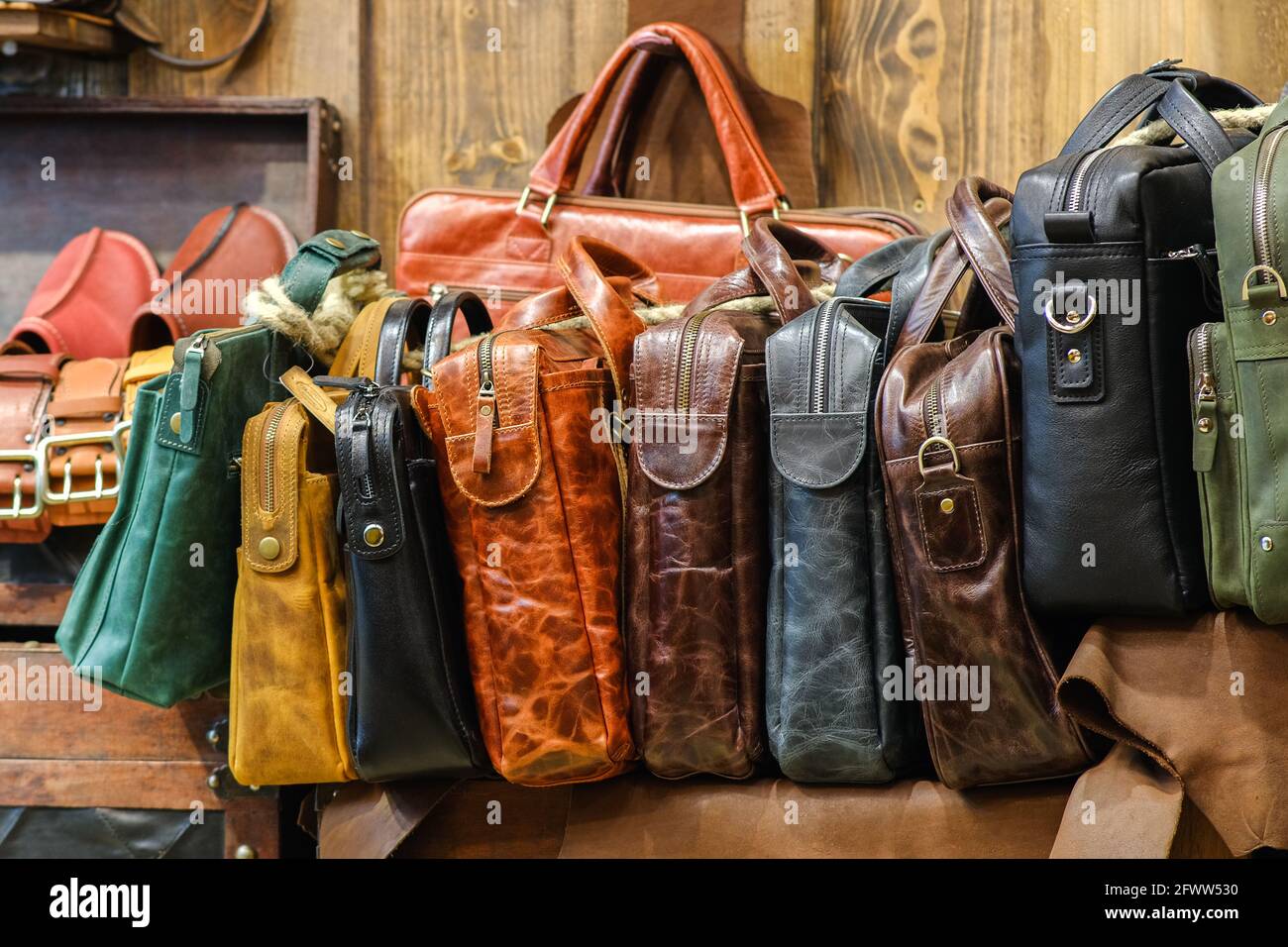 Leather bags of business style in different colors. The assortment is on the store counter. Handmade concept Stock Photo