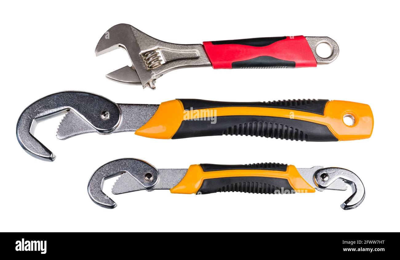 Set of metal hand tools for tightening nut or bolt. Closeup of adjustable wrench with red grip or two self-adjusting spanners with yellow black handle. Stock Photo