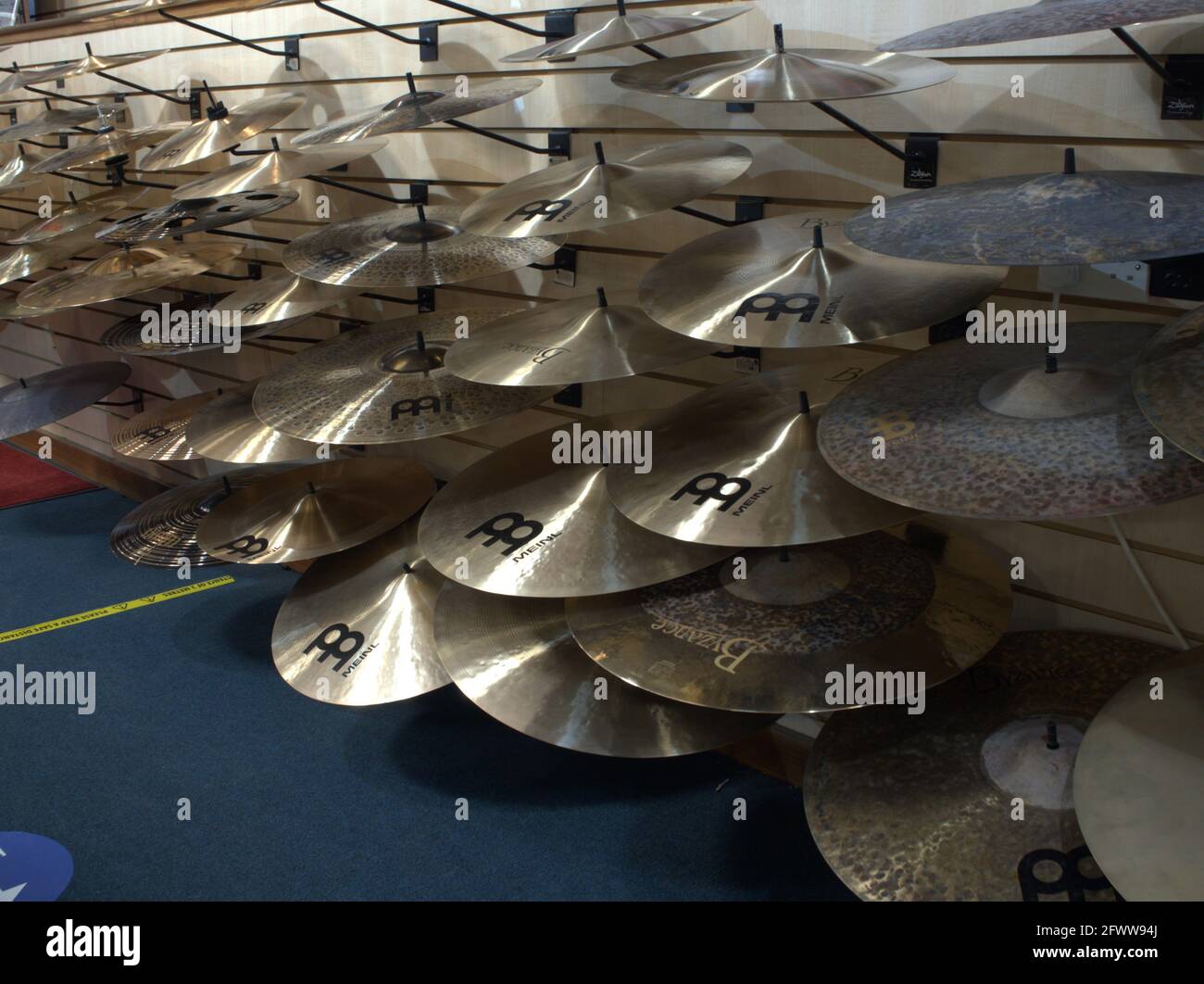 Cymbals Hanging up on a display wall Stock Photo