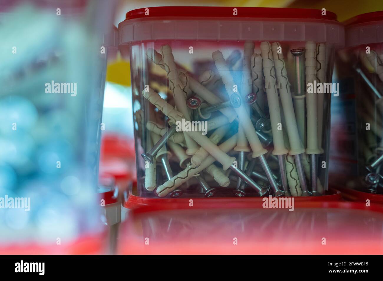 Group of plastic containers with nails sold in hardware store Stock
