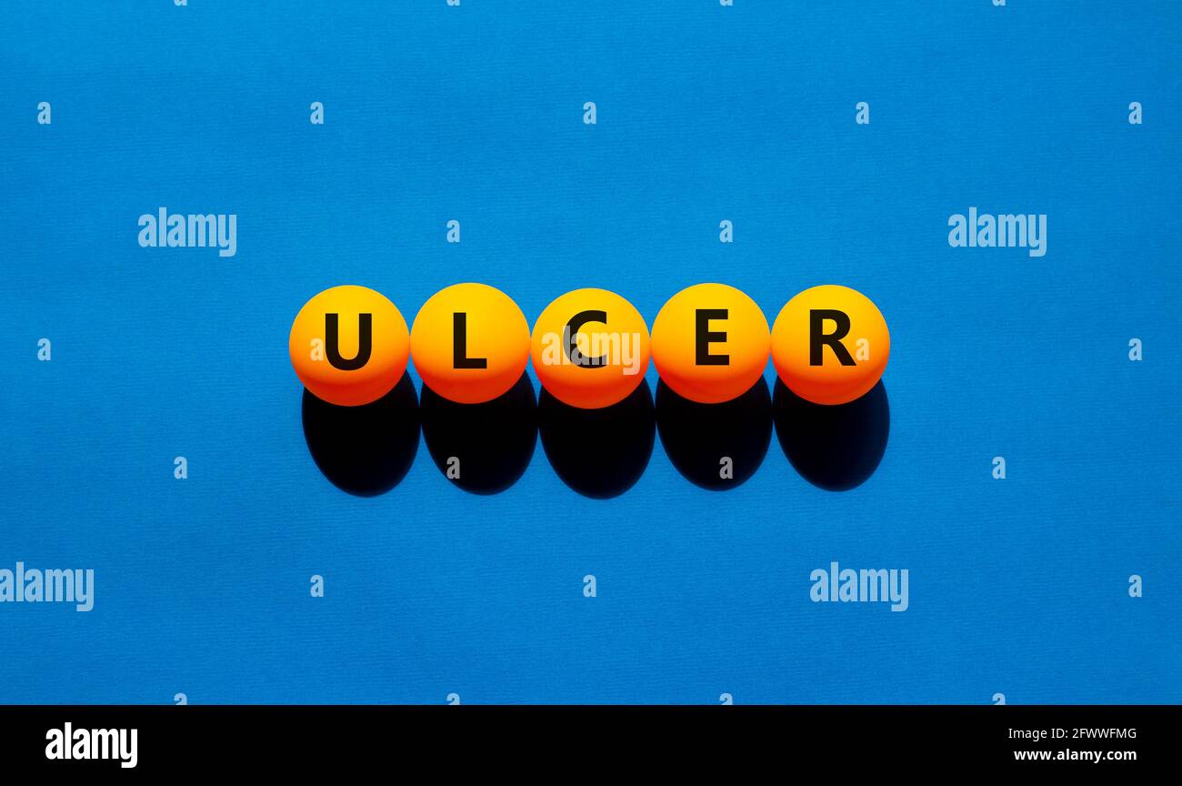 Stomach ulcer symbol Orange table tennis balls with the word ulcer 