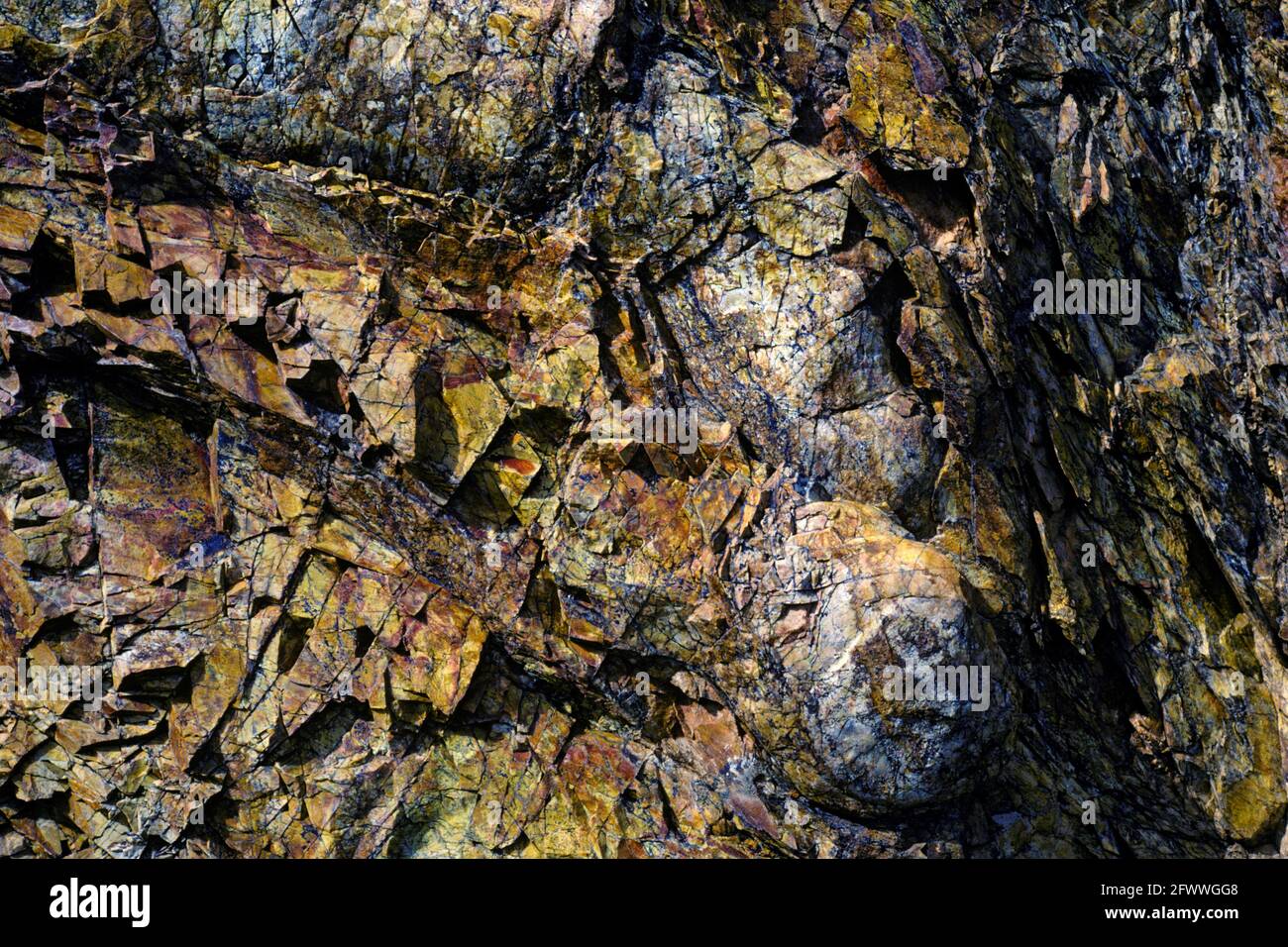 Hydrothermally altered shales have fractured and deformed in a colorful metasedimentary rock formation in California's Argus Range. Stock Photo