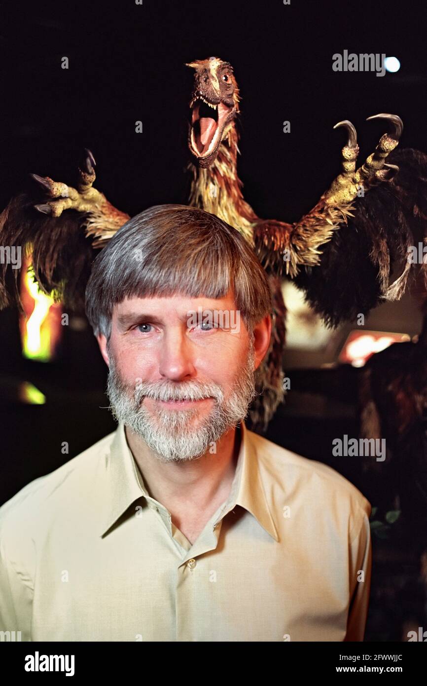 The San Diego Natural History Museum hosted an exhibit on feathered dinosaurs.? Dr. Czerkas Stephen is at the center of the debate on where dinosaurs end and birds begin.? The deinonycus behind him is his own life-size sculpture of the winged but flightless proto-bird.?He directs the Dinosaur Museum; Blanding; Utah. Stock Photo